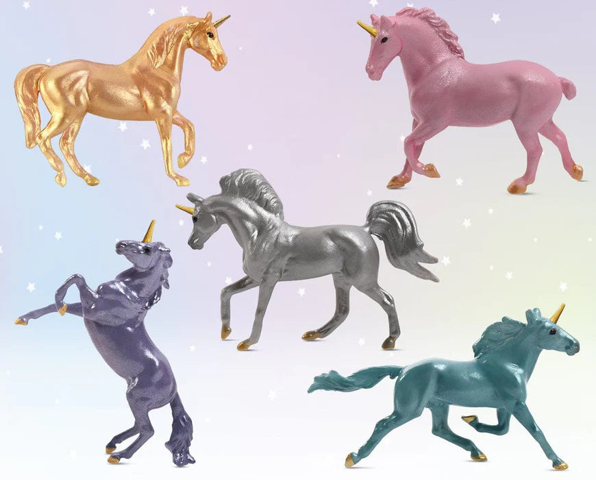 Five colorful unicorn figurines on a gradient background