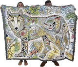 Two people holding a colorful blanket with animal designs.