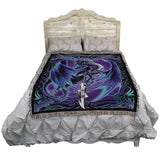 Bed with a decorative blanket featuring a purple and blue dragon design on a white background