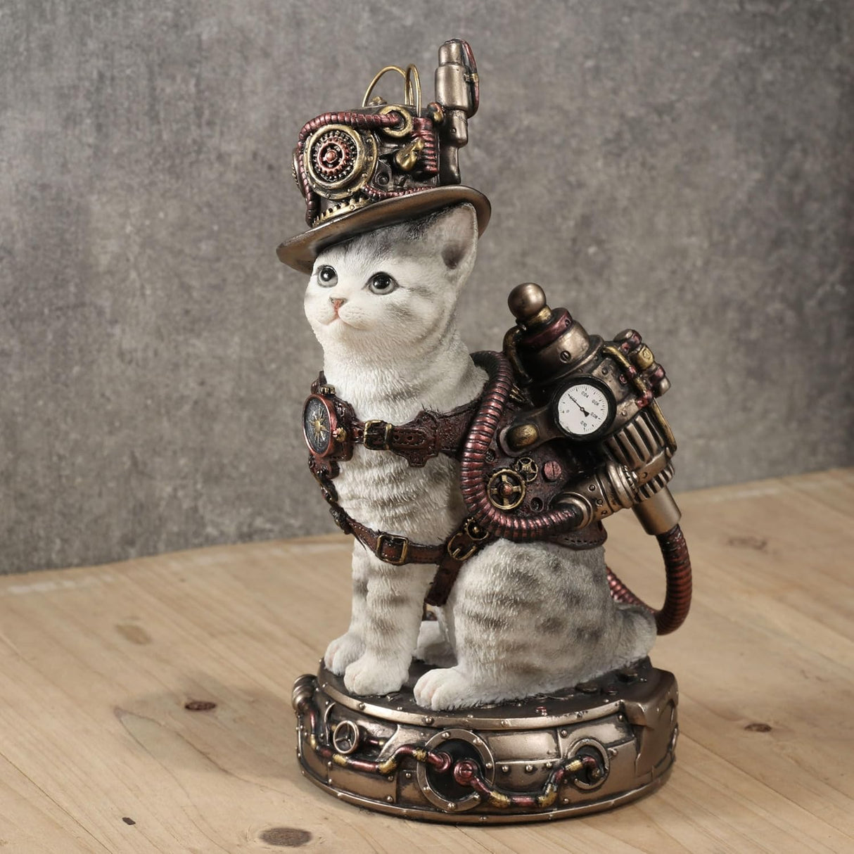 Figurine of pale gray tabby cat with Steampunk hat and gear on a matching base