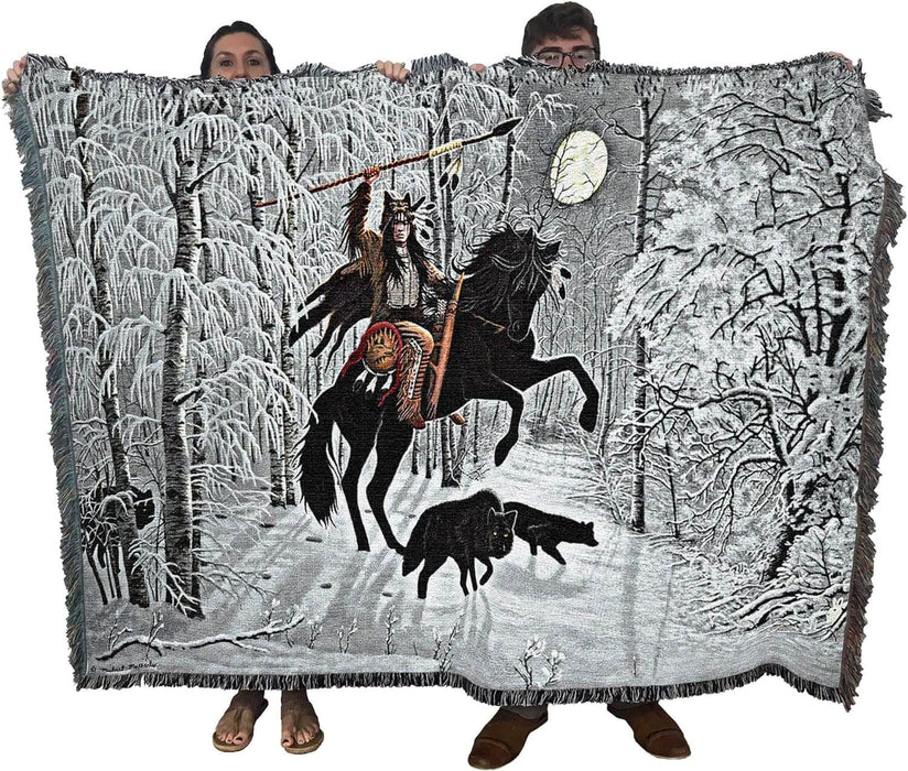 Tapestry blanket held up by two adults to show large size