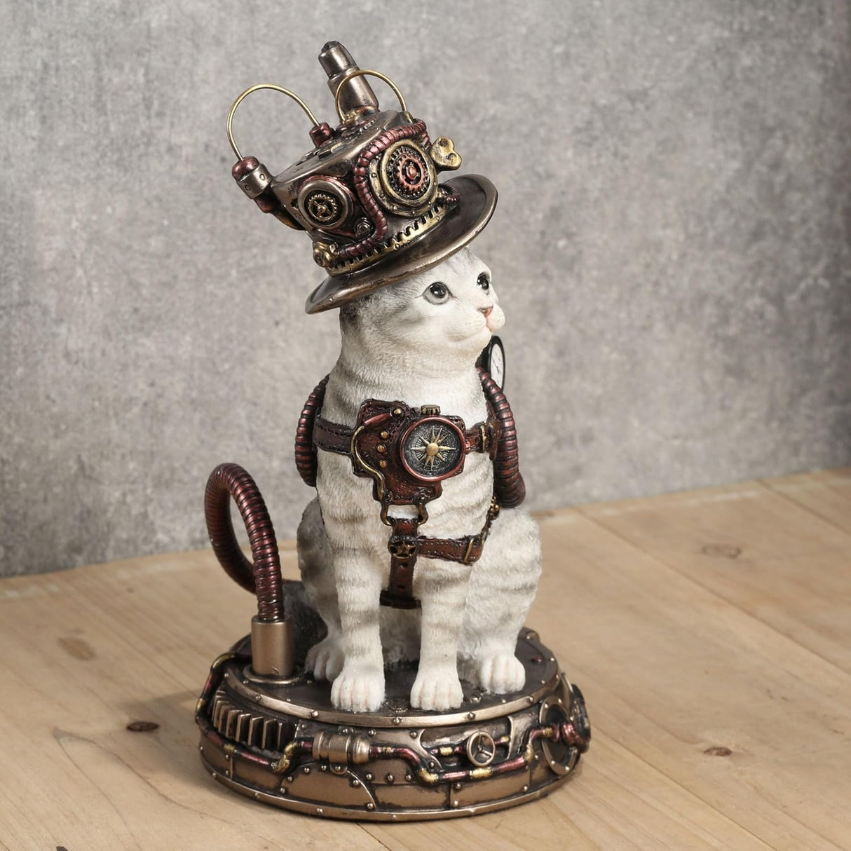 Figurine of pale gray tabby cat with Steampunk hat and gear on a matching base