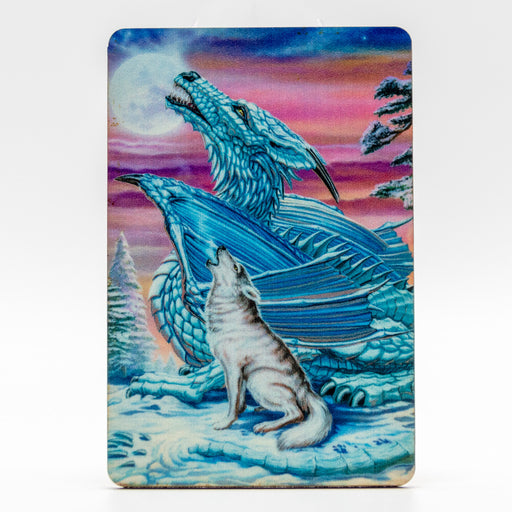 Magnet with a blue dragon and gray wolf howling at the moon together in the snow with a sunset.