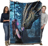 Two adults holding up tapestry blanket to show large size