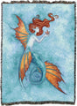 Tapestry blanket showing Mermaid with orange and blue tail gazing at starfish on a textured blue background