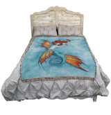 Bed with a decorative blanket featuring a mermaid design