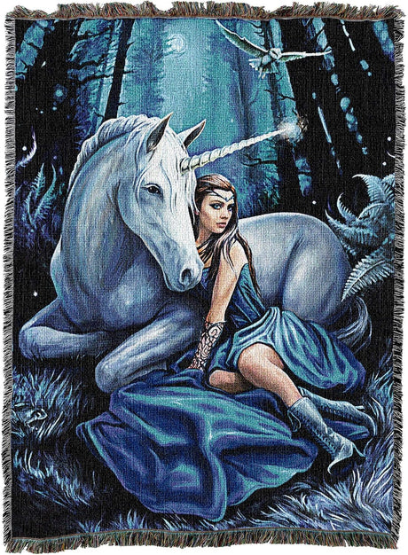 Tapestry blanket of a woman in blue dress and unicorn with glowing horn in a moonlit forest at night