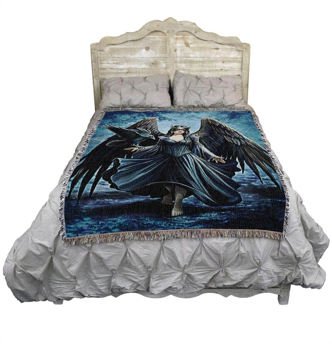 Raven angel blanket shown on a bed