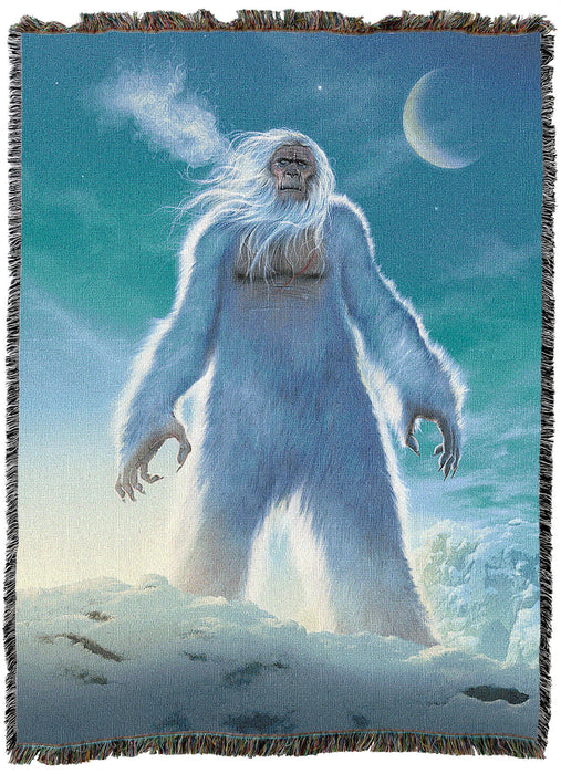 Tapestry blanket showing a standing Yeti snow monster in an icy landscape with the moon in the blue sky