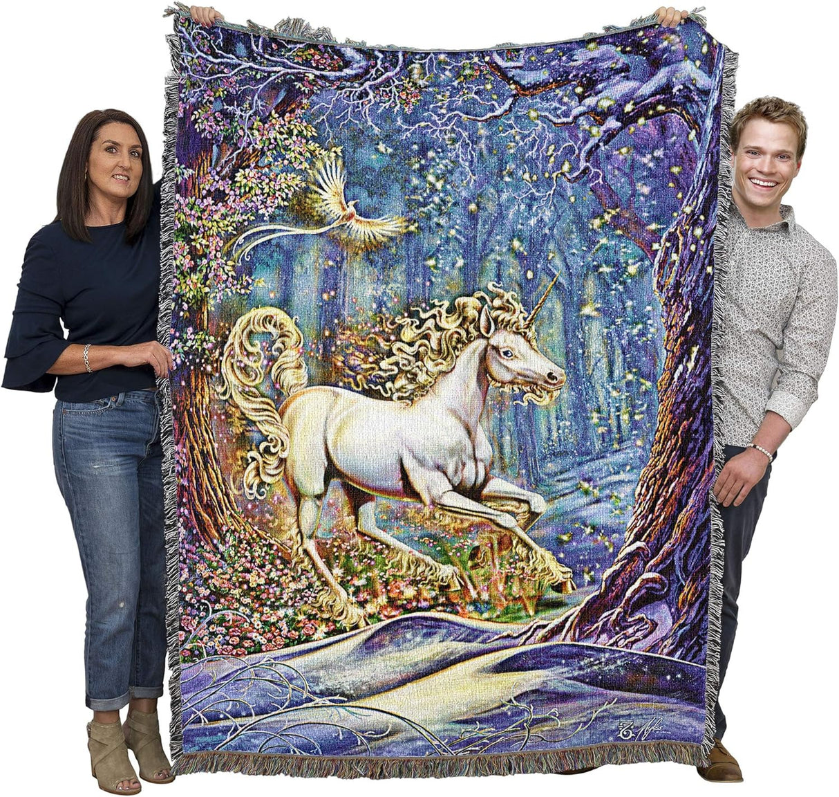 Two people holding a tapestry with a unicorn design in a fantasy landscape.