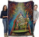 Tapestry blanket with art by Myles Pinkney. Wizard stirring a cauldron with magical dragons in the air above. Shown held by two adults