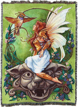 Tapestry blanket with fairy in gold armor and golden hummingbird. Pixie perched on stone gargoyle face, surrounged by blossoms and blackberries.