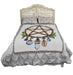Pentacle charm tapestry blanket shown draped over a bed