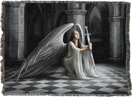 Tapestry blanket, art by Anne Stokes. Angel with white feathered wings and dress kneeling with a sword, gazing up into light, Gothic shadowy architecture behind her, checkered floor
