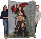 Two adults holding up large tapestry blanket