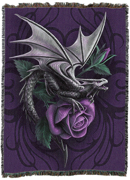 Tapestry blanket with art by Anne Stokes showing a dragon perched on a purple rose. Violet backdrop with tribal designs