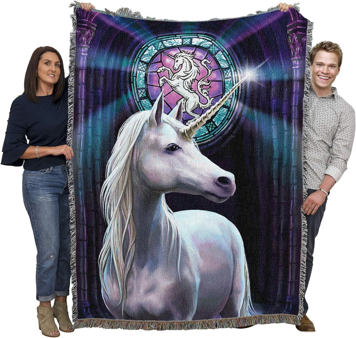 Tapestry blanket with white unicorn standing before a stained glass window, held by two adults to show large size