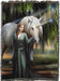 Tapestry blanket with art by Anne Stokes featuring a woman in green with a unicorn standing amidst mossy trees.