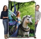 Tapestry blanket of fairy with dragon on wrist riding unicorn through green forest