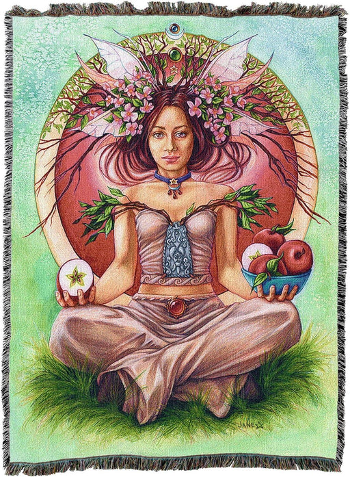 Tapestry blanket of a fae woman sitting cross legged in the grass with a bowl of apples and a crown of apple blossom branches in her hair