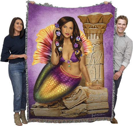 Tapestry blanket by Brigid Ashwood, mermaid with pansy flowers in dark hair next to stone ruins, held by adults to show large size