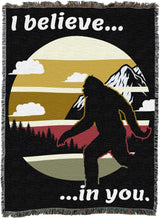 Tapestry blanket with Bigfoot silhouette and phrase "I believe... ...in you." 