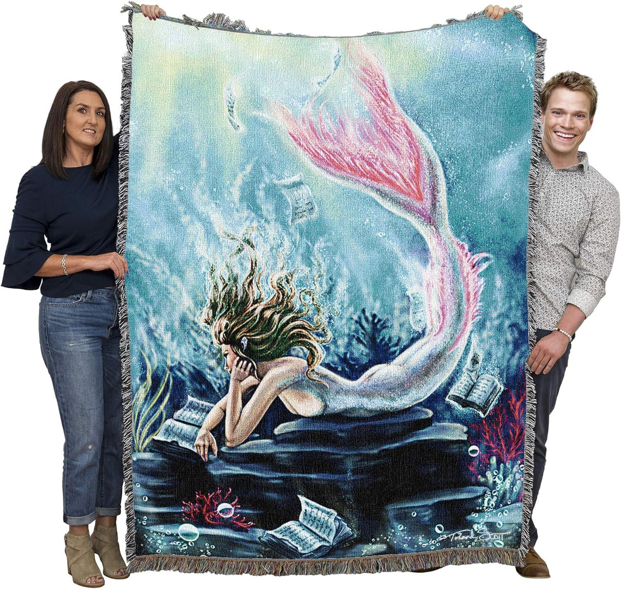 Two adults holding up mermaid tapestry blanket to show large size