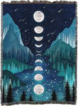 Woven blanket with moon phases and mountain landscape design