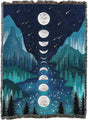 Woven blanket with moon phases and mountain landscape design