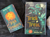 Trick or Treat Tarot deck with companion guide by Barbara Moore, displayed on a dark fabric background.