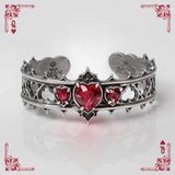Pewter bracelet with red heart stones on a white background with playing card designs