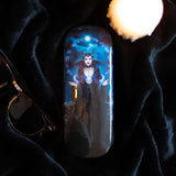 Eyeglass case with witch in black casting a spell under a full moon