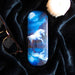 Moonlight Unicorn glasses case shown with candle and eyeglasses on a black cloth (not included)