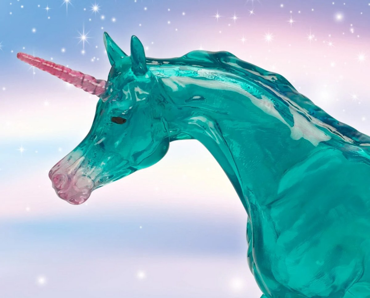 Model unicorn with clearware aqua body, bust shown with pink accents