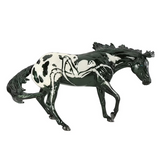 Model horse with black and white spider pattern on a white background