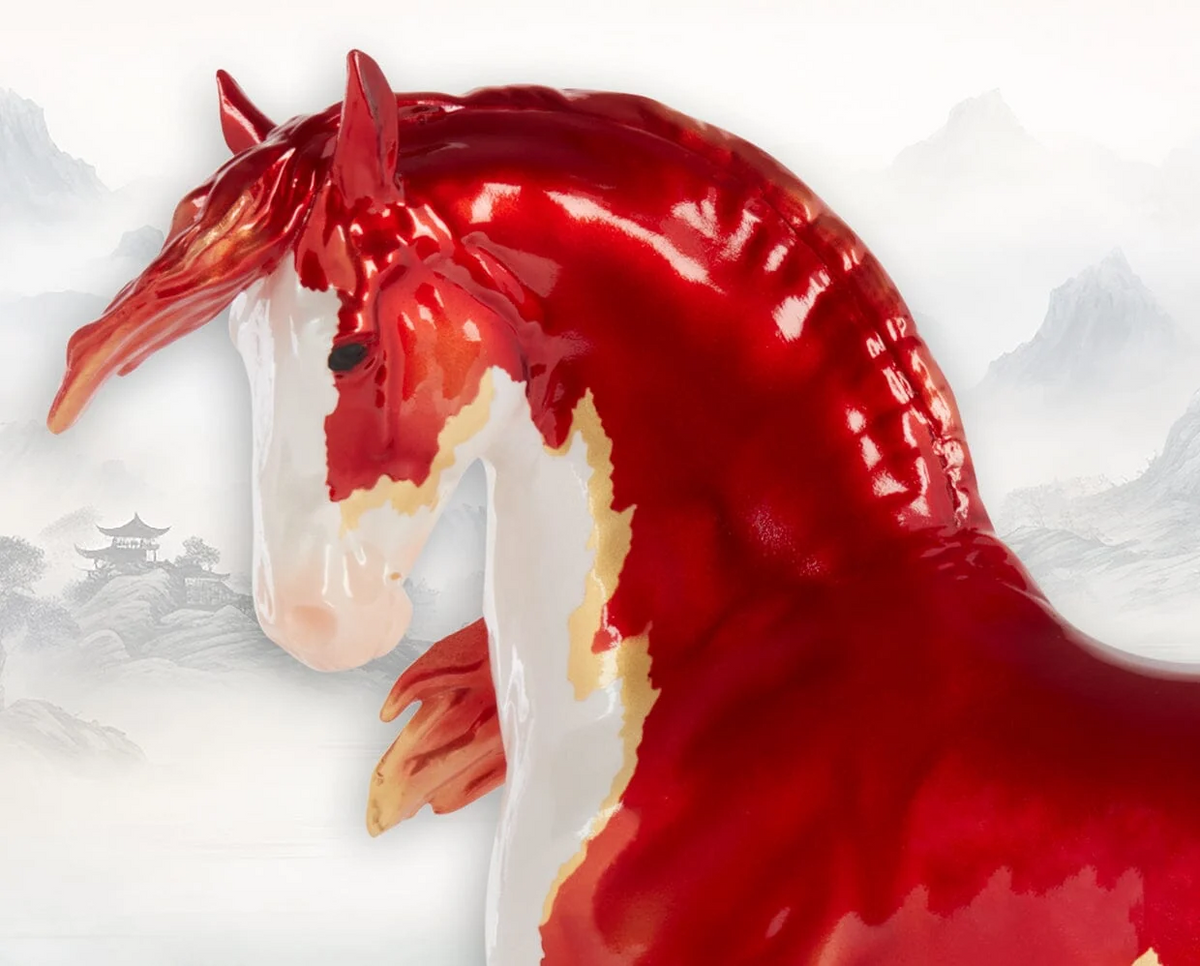 Closeup of Model horse figurine - Chinese Fire Horse - pinto with red and white with gold accents