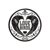 Ceramic coaster, white with two black ravens and phrase "Love Birds" in the heart their wings form