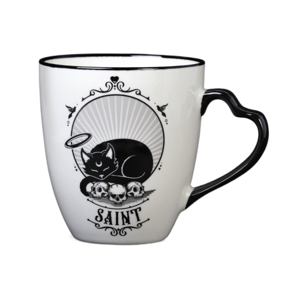 White mug with black design - one side says "Saint" with sleeping angel cat