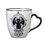 White mug with black design - one side says "Sinner" with devil cat