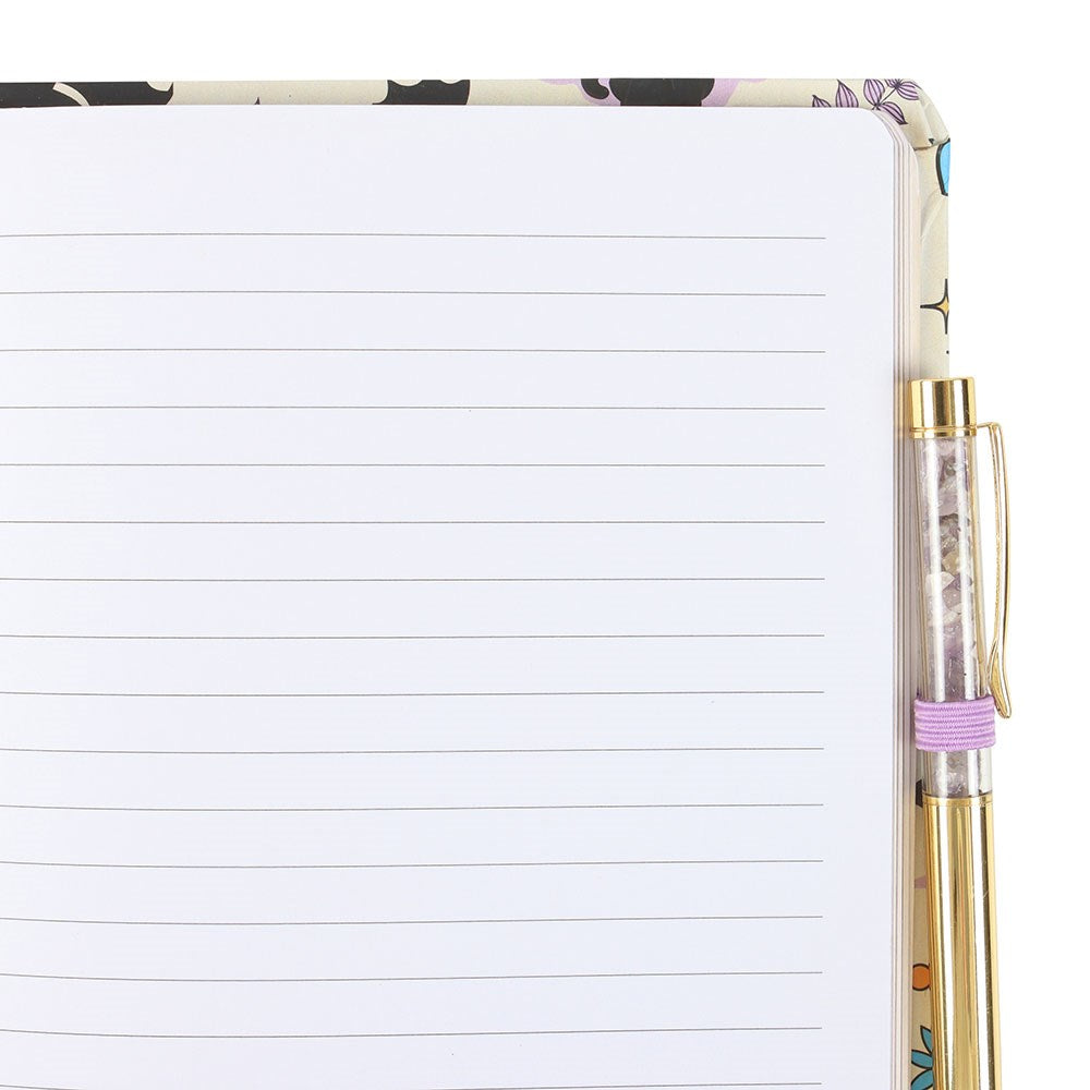 Notebook with black cat and bat pattern and pen. showing lined pages