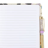 Notebook with black cat and bat pattern and pen. showing lined pages