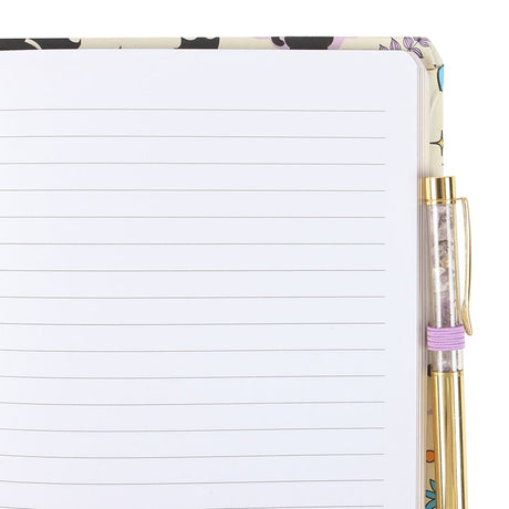 Notebook with black cat and bat pattern and pen. showing lined pages