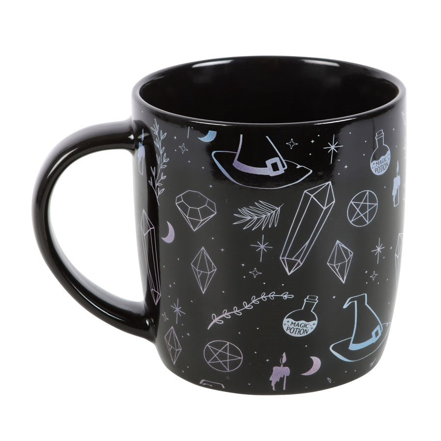 Mug with designs of crystals, witch hats, moons, stars, potion bottles, candles on black background