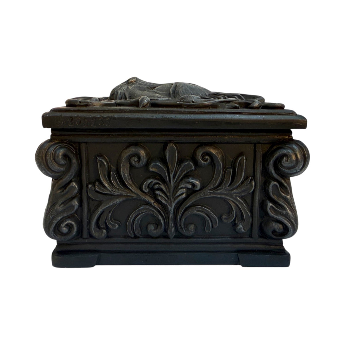Black trinket box with cat face on lid, shown from the side with swirls