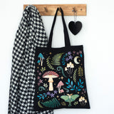 Tote bag with design of mushrooms, ferns, moon, luna moth, flowers