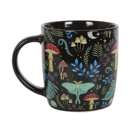 Black ceramic mug with designs of mushrooms, ferns, luna moths