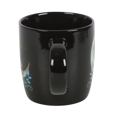 Black ceramic mug with crescent moon and mushroom design