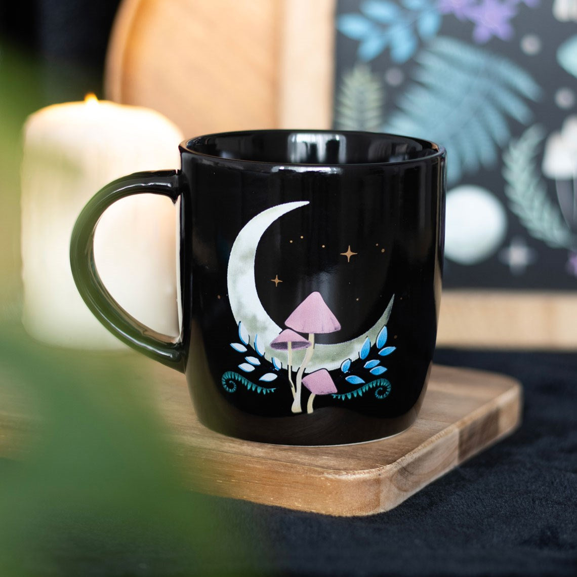 Black ceramic mug with crescent moon and mushroom design