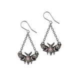 Luna moth-shaped earrings with chain details on a white background