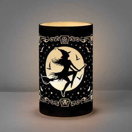 Lantern light of black etched glass with witch riding broomstick in front of a full moon. Bats and stars and witchy accents